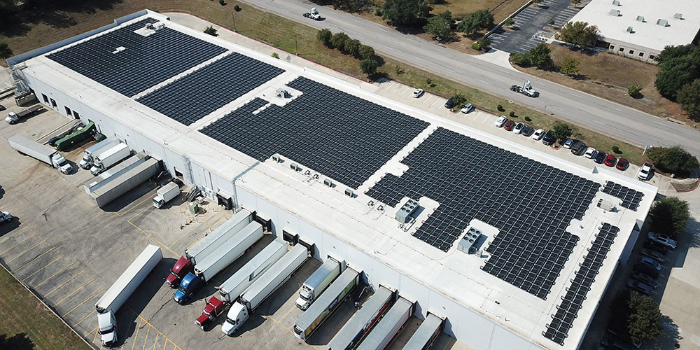 Solar panels atop an industrial building.