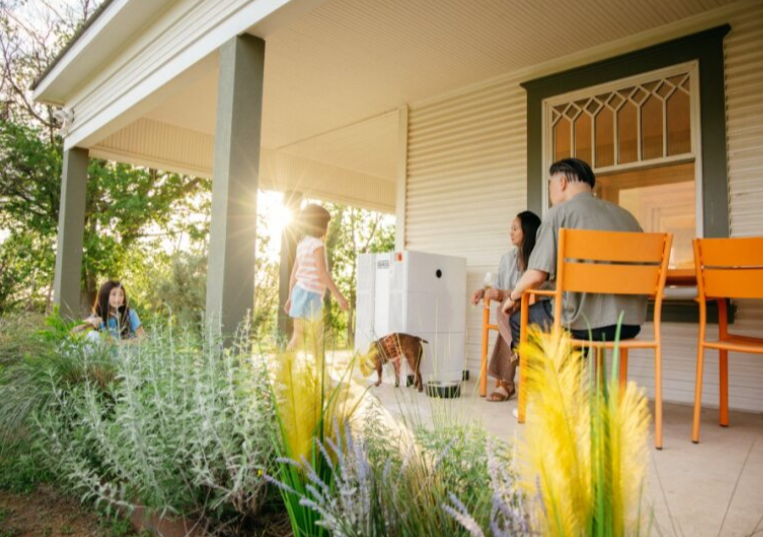 Family with dog sitting on porch