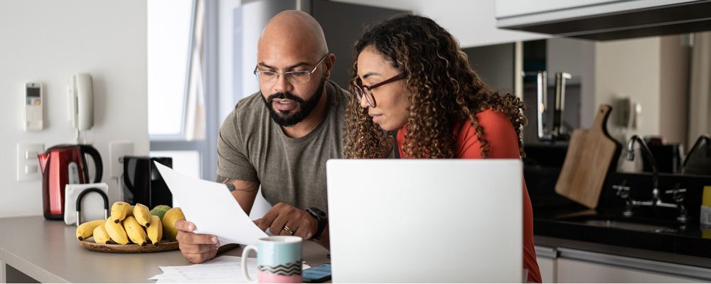 Man and woman analyzing a document in the kitchen