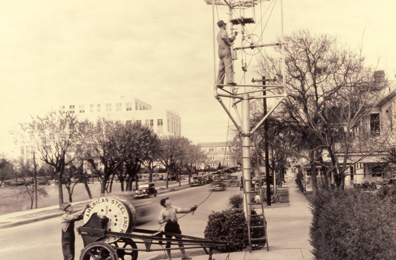 Workers installing electric cable in moonlight tower