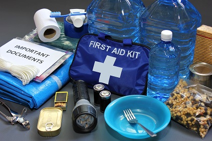Emergency kit with essentials such as water, first aid, medicines, toiletries, and food