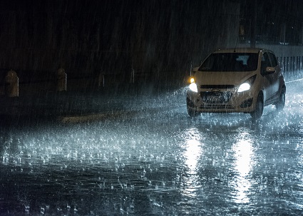 Car driving at night during a rainstorm